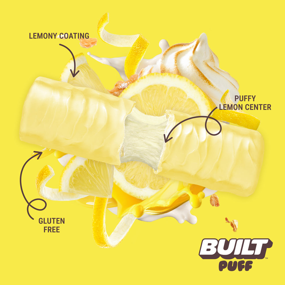 Built Bar Puffs Canada – Lemon Meringue Pie Protein Bar 40g partially unwrapped showing lemony coating and fluffy lemon center on yellow background
