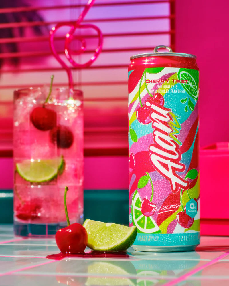 Alani Nu cherry limeade can with a glass of cherry limeade and lime slices on a colorful background