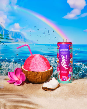 Can of Hawaiian Energy drink with pink coconut drink on a beach with rainbow