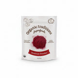 Package of Organic Traditions Beetroot Powder on a red textured background